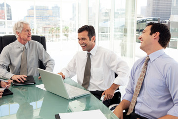 business people in a meeting - successful corporate executives laughing