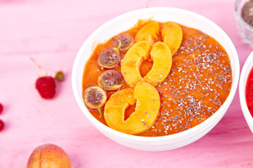 Smoothie bowls. Healthy breakfast bowl on pink background.