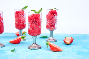 Summer refreshing strawberry sorbet, slush granita drink in serving glasses.