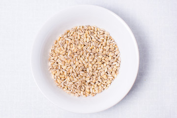 sesame seeds in a bowl isolated on white