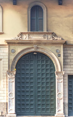 Obraz premium milan - italy, a luxurious marble entrance to an elegant building with a carved wooden door