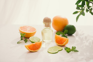 organic cosmetics with herbal extracts of lemon, orange, mint on bright background