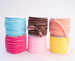 reels with colorful decorative textile ribbons for packing bouquets and gifts. floristics, packaging and needlework concept