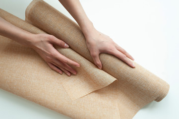 a roll of flax of light color in the hands