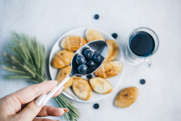 healthy light breakfast. blue tea from orchids, blueberries on a spoon, croissant on a plate with spikelets of wheat. top view proper nutrition for a slim figure. raw food vegetarianism. diet