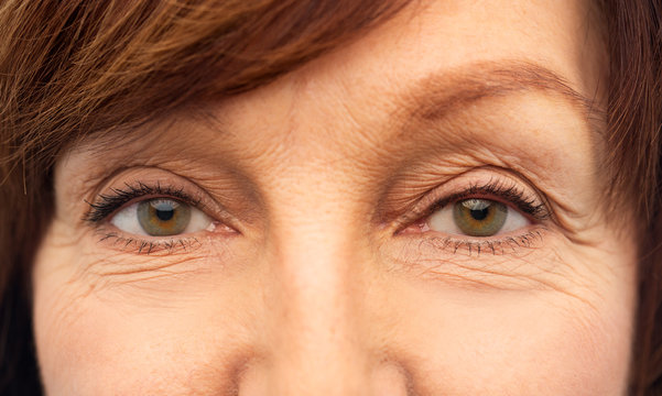 beauty, vision and old people concept - eyes of senior woman