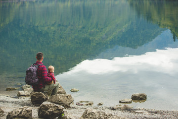 Dad and son walk by the lake