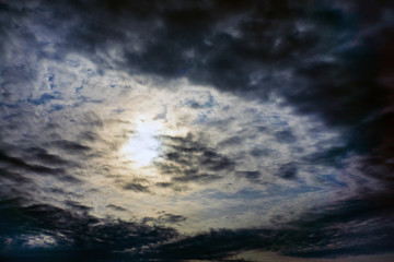 Fototapeta na wymiar gloomy clouds the sun through the clouds