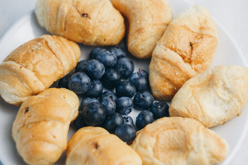 healthy light breakfast. blueberries, croissants on a plate. close up, top view. proper nutrition for a slim figure. raw food vegetarianism. diet