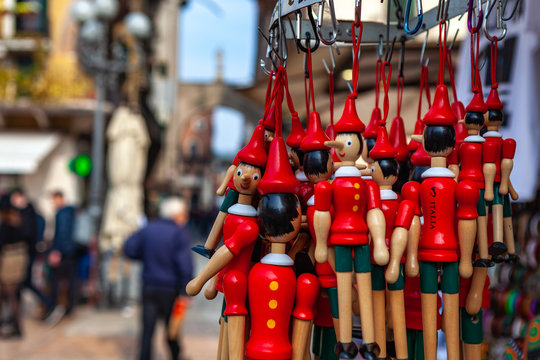 Verona, Italy &ndash; March 2019. Pinoccio dolls at market in Historic town square Elbe with stairs surrounded by cafes and buildings of peculiar architecture, Verona, Italy, Europe
