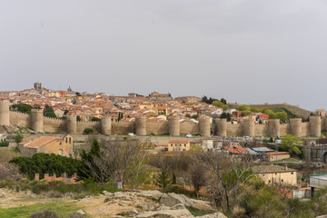 Fototapeta na wymiar Travel, View of the medieval wall of the city of Avila, in Spain. Spanish fortress