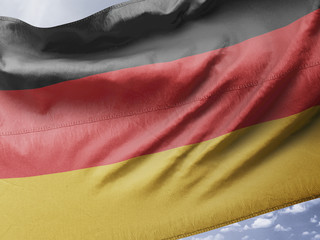 Germany national flag silk fabric on blue sky textile cloth fabric waving