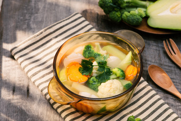 Assorted vegetables in glass pot on a napkin close up
