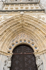 Obraz premium entrance with stone arch with reliefs, The Cathedral of Christ the Savior is a temple of catholic cult of the Spanish city of Ávila, episcopal headquarters of the same name, in Castile and Leon.