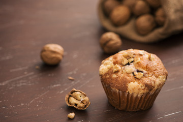 Tasty homemade walnut muffins on table. Sweet pastries