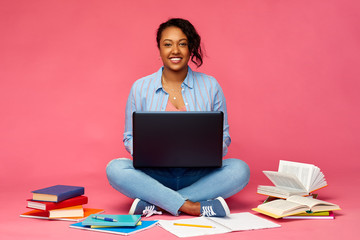 education, high school and technology concept - happy african american young student woman with...