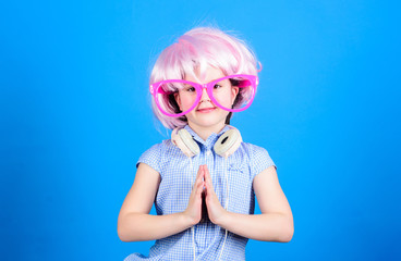 Adorable headset user with praying hands. Small child wearing adjustable white headset and pink...