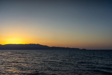 Fototapeta na wymiar Rock groyne at sunset, Crete, Greece