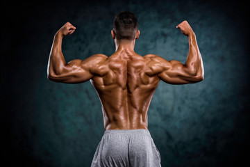 Fototapeta na wymiar Strong Muscular Men Flexing Muscles