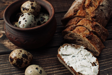 The bakery is a gold rustic crispy loaf of bread and rolls against the background of the table.