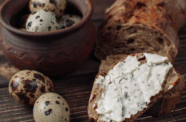 Bread on wooden table and eggs