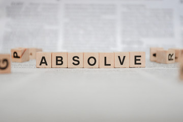 Absolve Word Written In Wooden Cube - Newspaper