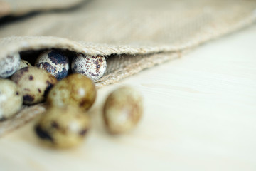 basket of quail eggs on burlap, very soft blur. village theme.rustic style