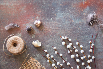 Natural springtime decorations around: quail eggs and feathers, pussy willow flowers