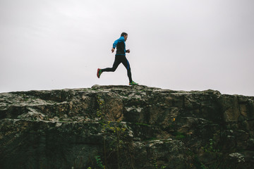Sport running man in cross country trail run