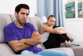 Fototapeta premium Guy on couch after discord with girlfriend