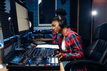 Obraz na płótnie Canvas Female sound operator in audio recording studio