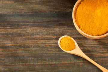 Organic turmeric powder - Curcuma longa. Wood background
