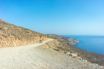Car on the mountain road on the way to the beach of Balos in Crete