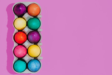Easter background with Easter eggs. Top view with copy space. multicolored Easter eggs on a pink background
