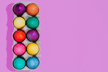 Easter background with Easter eggs. Top view with copy space. multicolored Easter eggs on a pink background