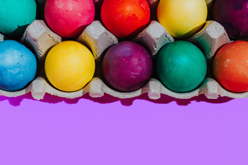 Easter background with Easter eggs. Top view with copy space. multicolored Easter eggs on a pink background