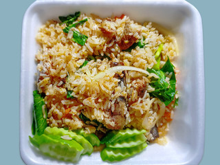 Traditional Canned Mackerel Fried Rice on Foam Tray Isolated on Cyan Background