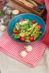 Pasta with pesto sauce and nuts on a the table