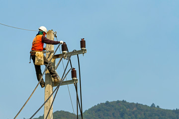Electrician man on electric pole to install new electric cable