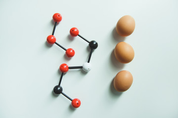 Raw hen eggs lying on white table in laboratory room