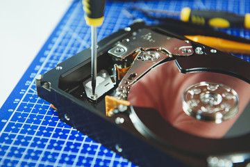 Cropped photo of master repairing HDD with screwdriver