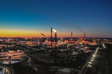 Russia. Ufa. April 2019. Башнефть Bashneft Flying above  chemical factory (refinery) in the late evening. Lights of night Ufa.