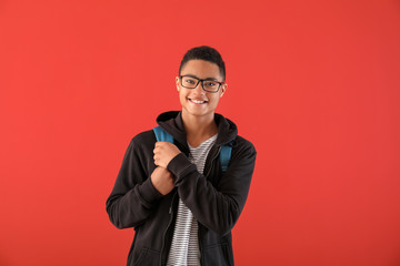 Portrait of African-American teenage boy on color background