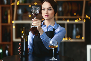 Female sommelier working in wine cellar