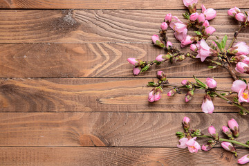 Beautiful blossoming branches on wooden background