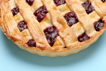 Tasty cherry pie on color background, closeup