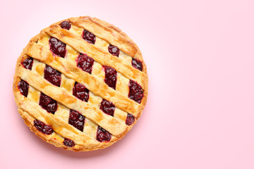 Tasty cherry pie on color background