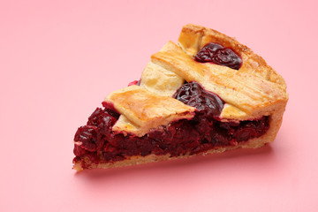 Piece of tasty cherry pie on color background