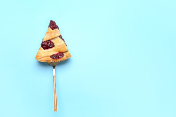 Piece of tasty cherry pie on color background