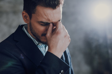 Puzzled young man is contemplating important issues
